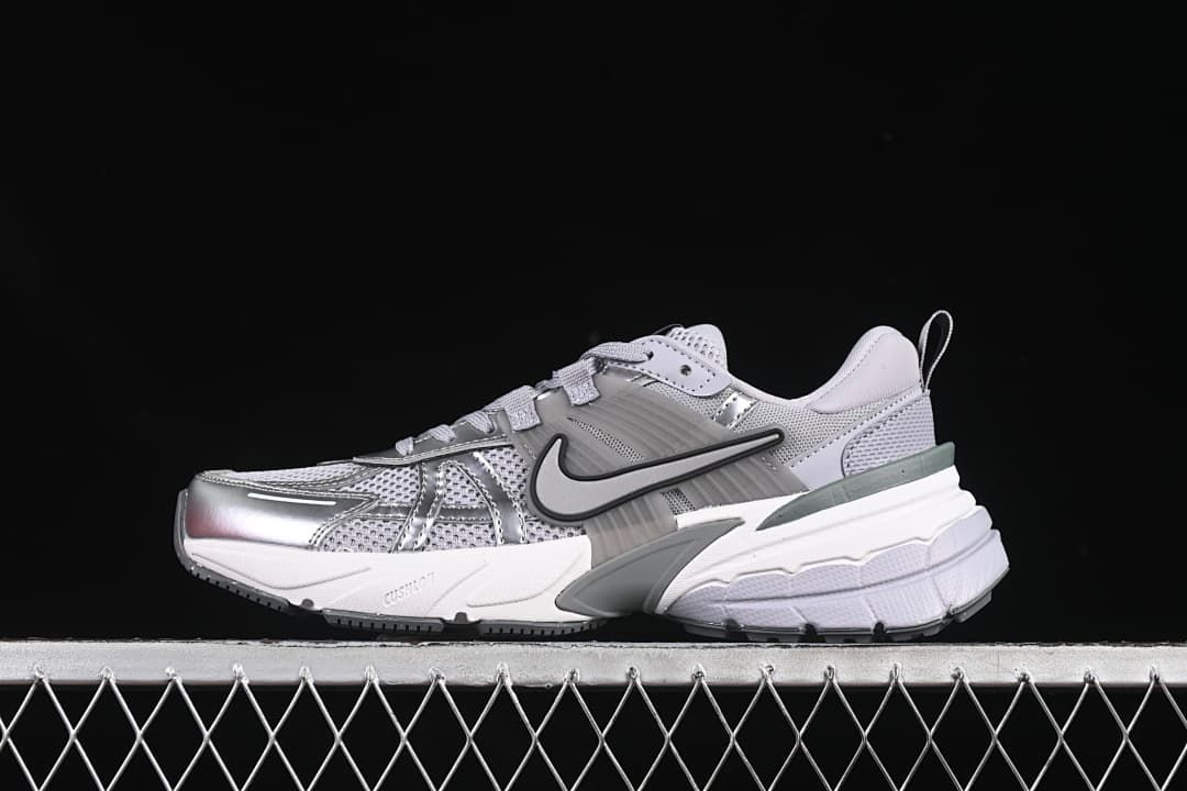 Nike V2K Run sneaker in silver, grey, and white shown in side profile