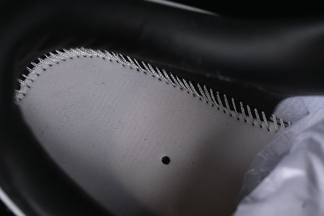 Close-up inside the sneaker showing stitching and the insole.