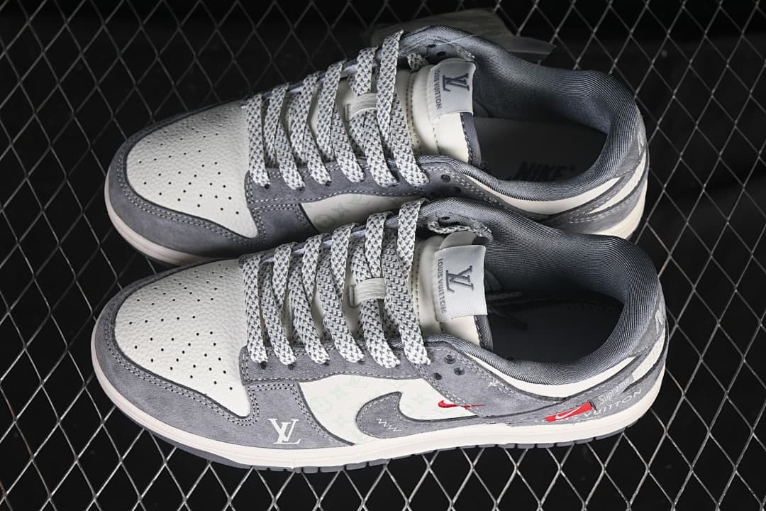 Top view of a pair of grey and white low-top sneakers with perforated toe panels and patterned laces