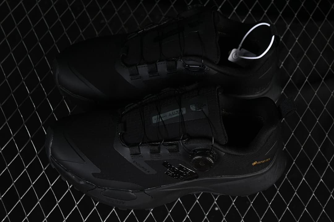 Pair of black low-cut shoes shown from above at an angle.