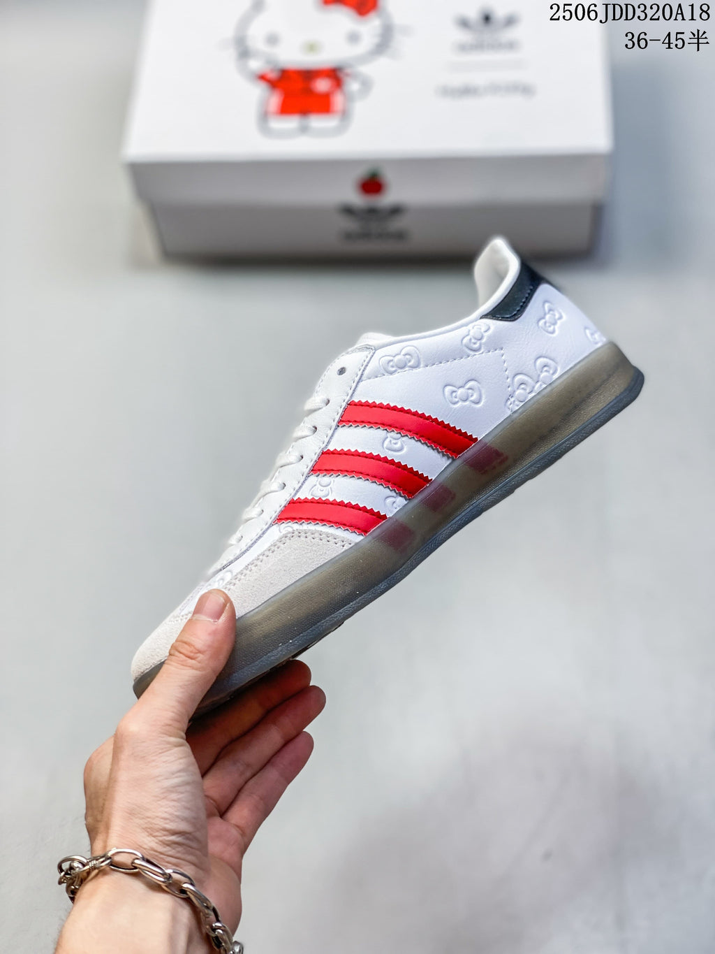 Side view of the sneakers with red stripes and embossed upper details