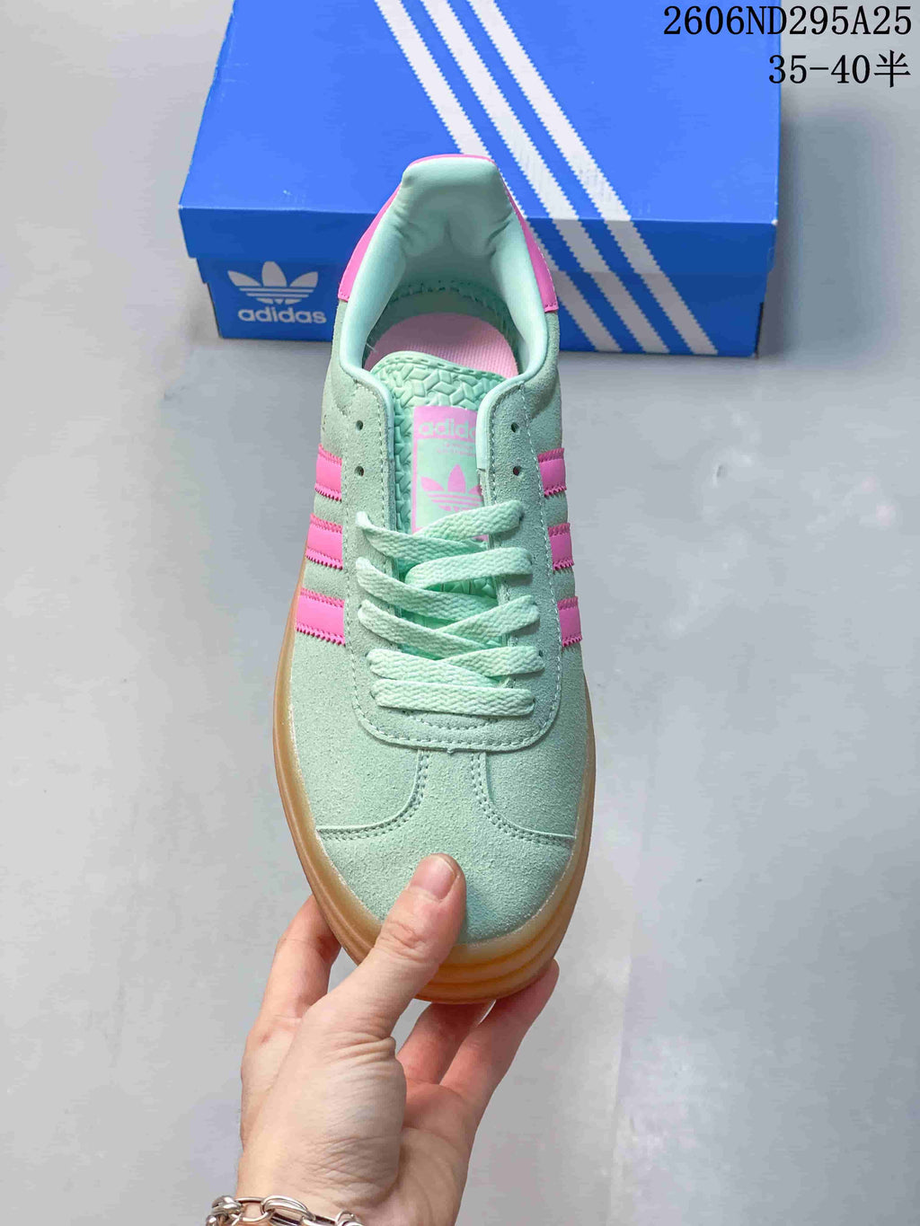 Top view of the lace-up sneaker with mint-green upper and pink accents