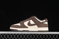 Side view of brown and off-white Nike SB Dunk Low sneakers against a black background