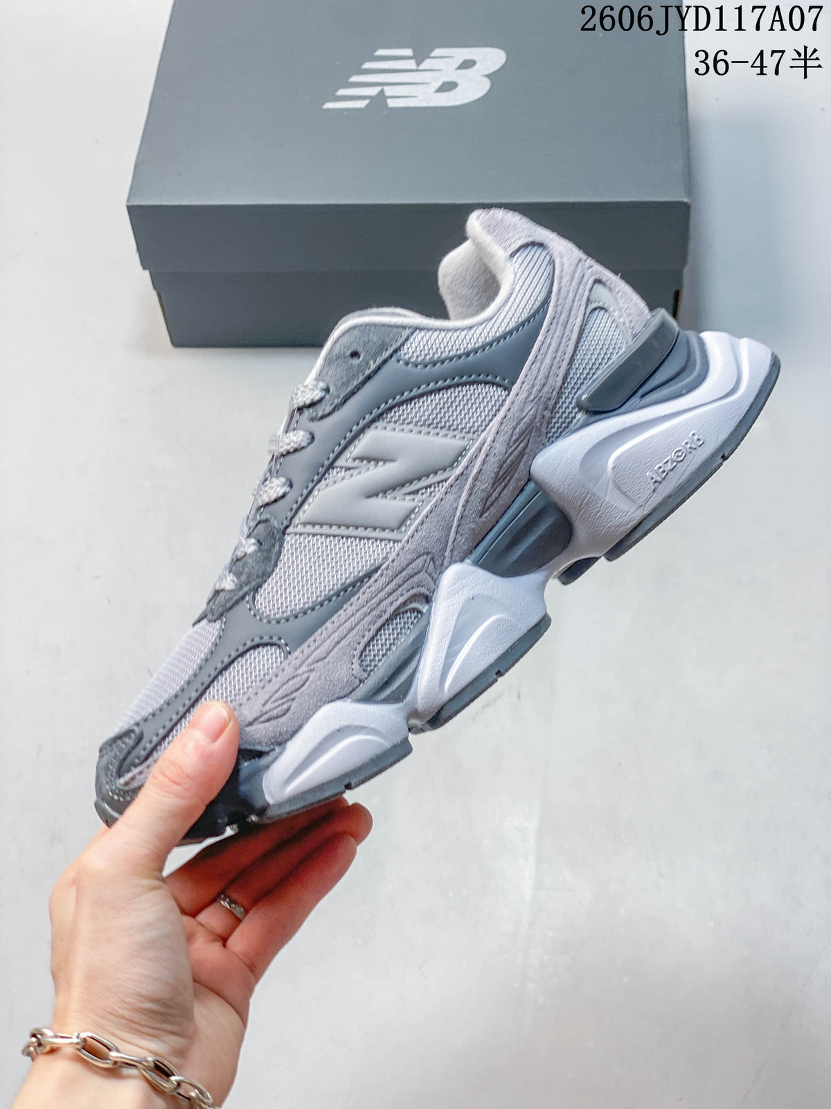 Side view of a grey New Balance 9060 sneaker showing layered panels and sculpted sole
