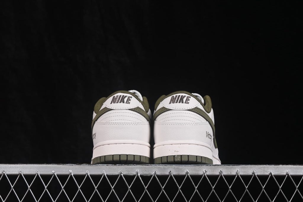 Rear view showing Nike heel branding, white heel panels, and olive outsole sections.