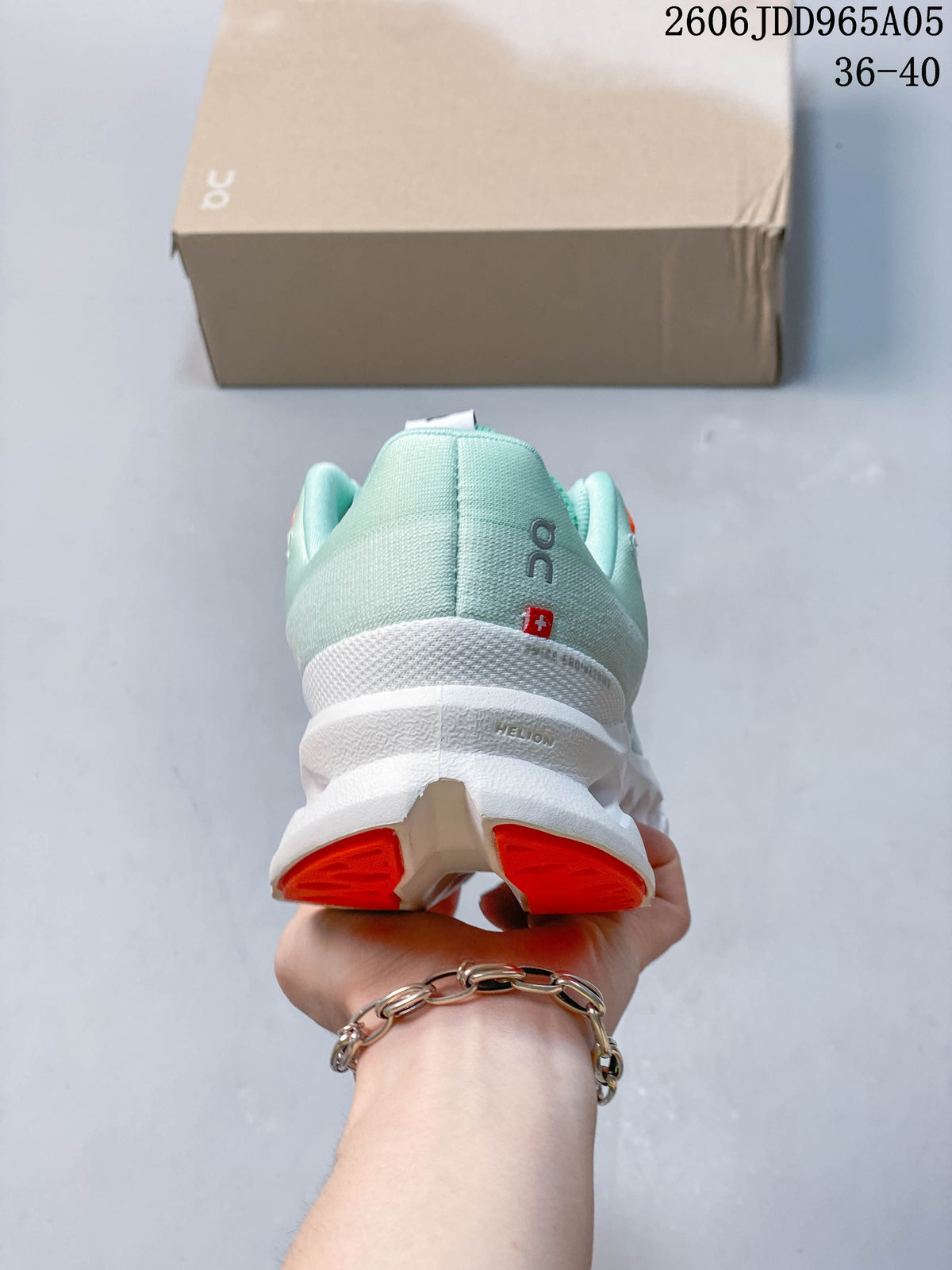Rear view of the shoe with mint heel and orange outsole accents