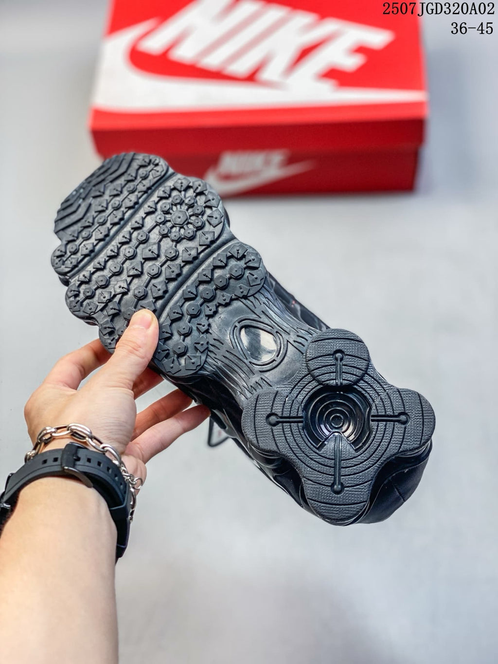 Underside of a black sneaker showing the outsole tread and heel detail
