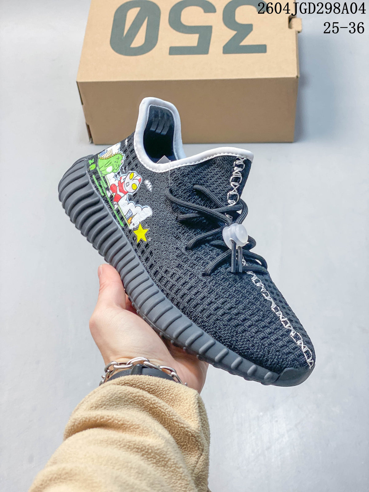 Close side view of a charcoal sneaker with cartoon graphics and lace-up detailing