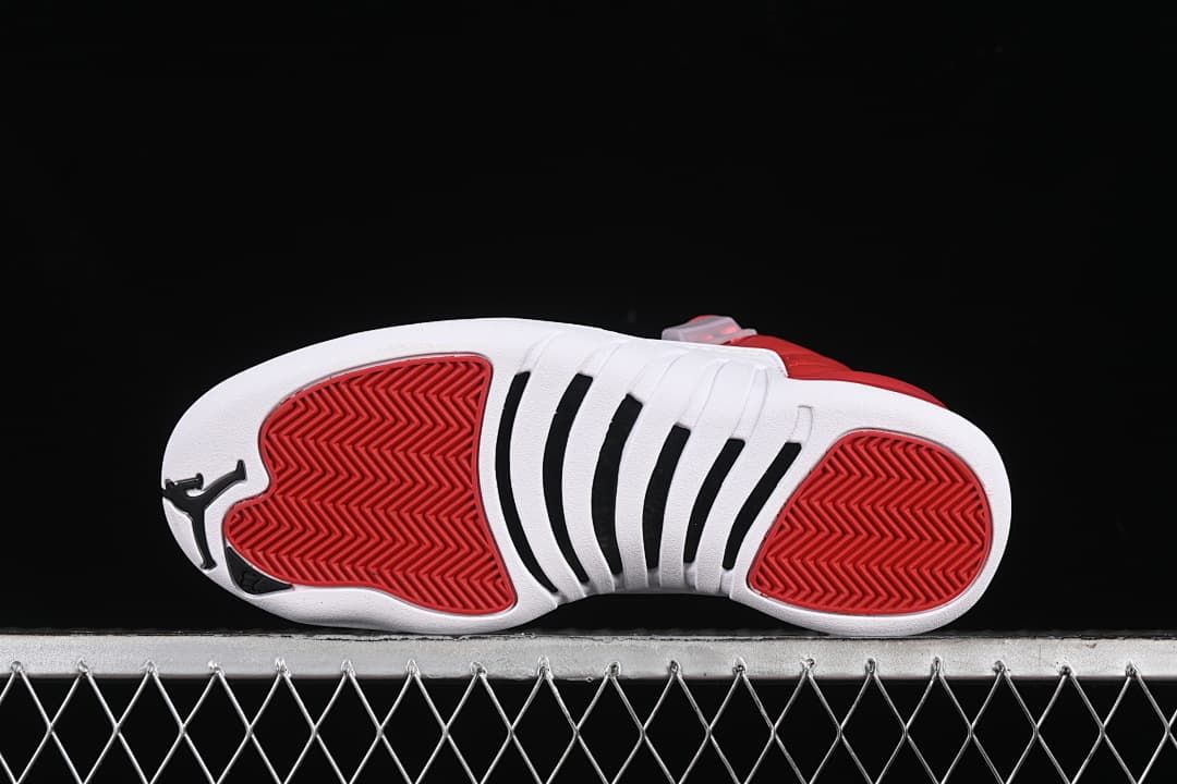 Outsole view showing red traction sections and black accents