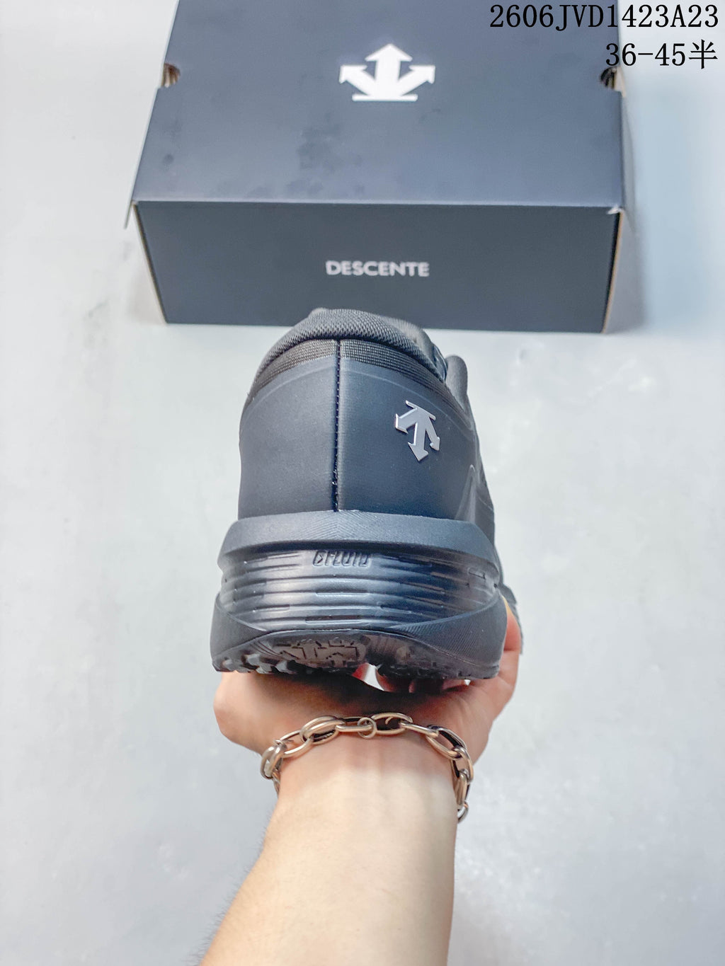 Rear view of the charcoal sneaker and heel.