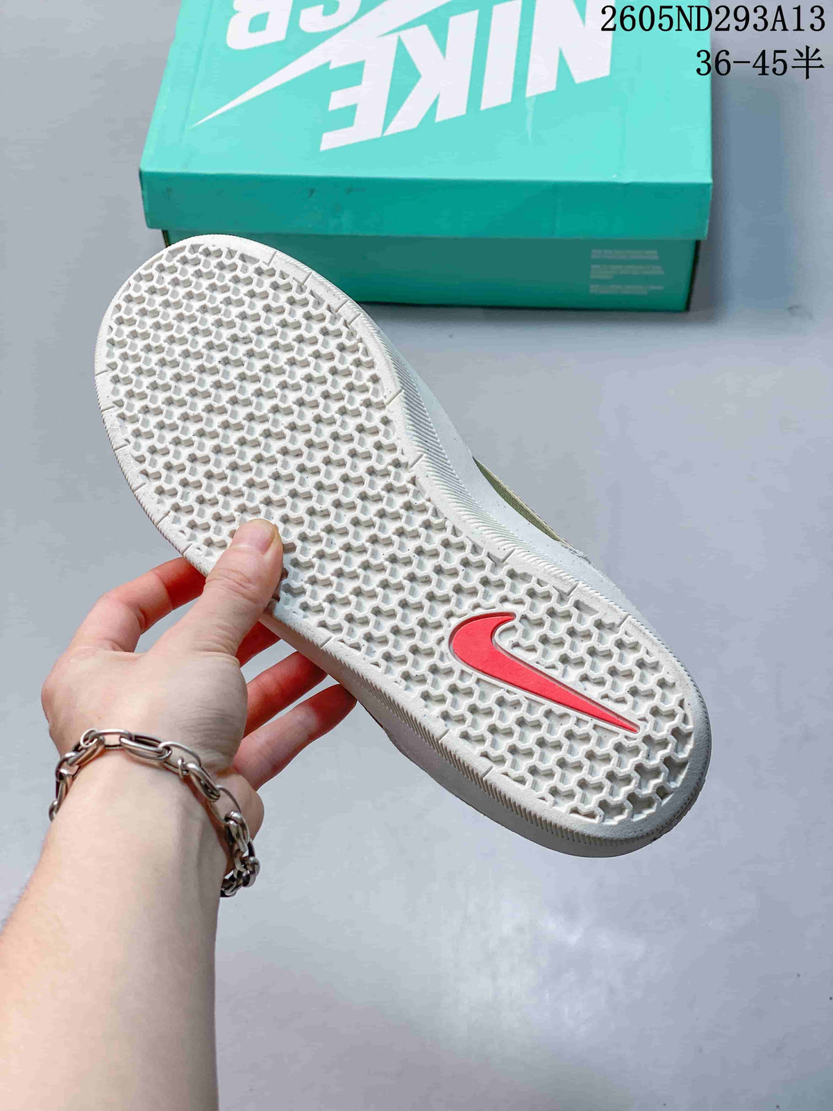 Close-up of the patterned rubber outsole with a pink Swoosh detail.