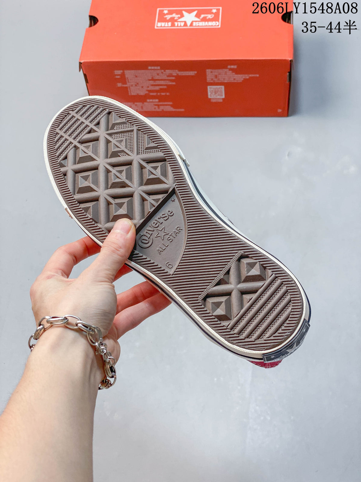 Underside of a Converse sneaker showing the patterned rubber outsole.