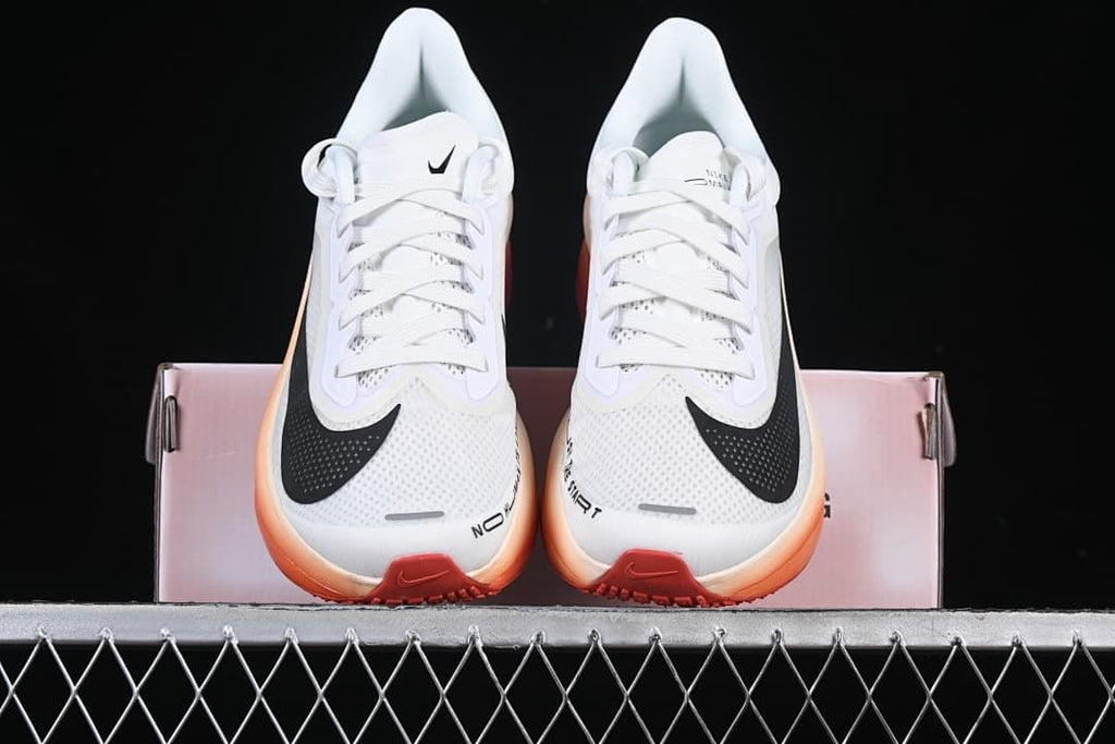 Front view of the pair highlighting the black toe Swooshes and orange sole edges