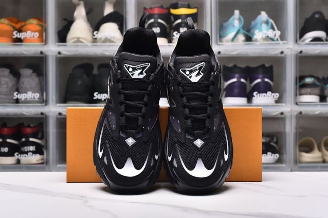 Front view of a pair of black Runner Tatic sneakers with pale accents
