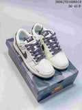 Pair of cream and grey low-top sneakers with dark patterned laces on a camouflage-patterned box