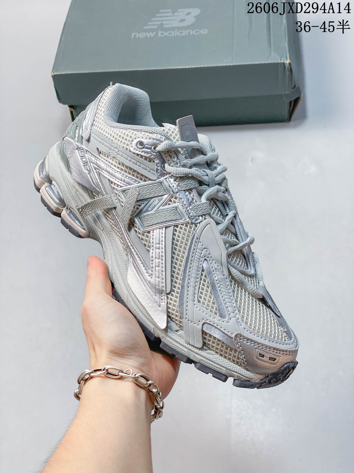 Angled side view of a silver-grey New Balance 1906 sneaker.