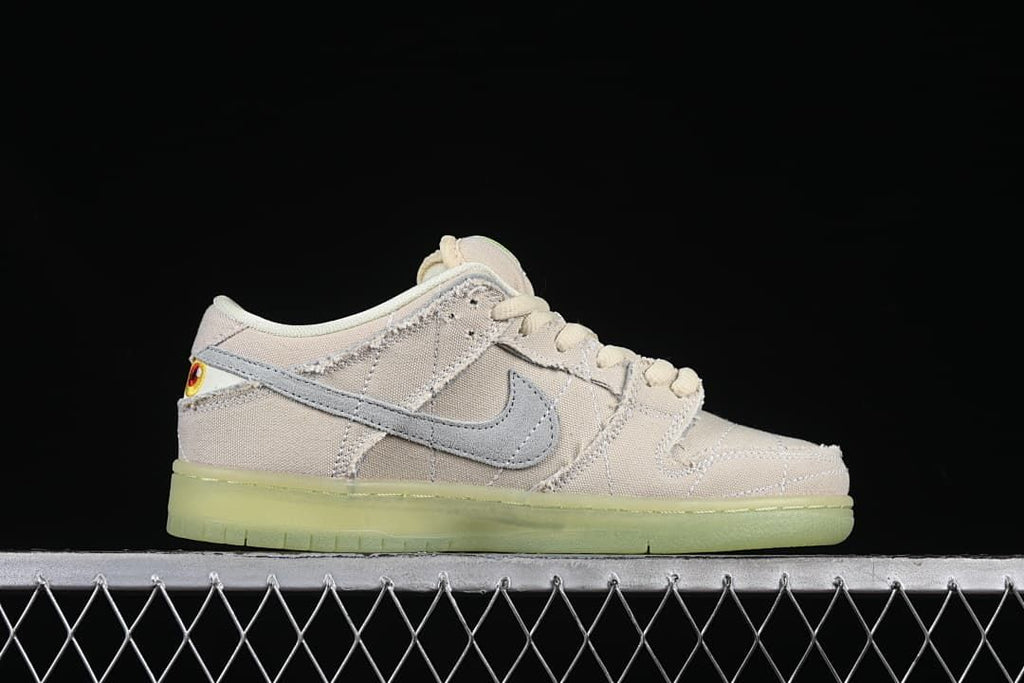 Side profile of the shoe showing the gray Swoosh and pale upper