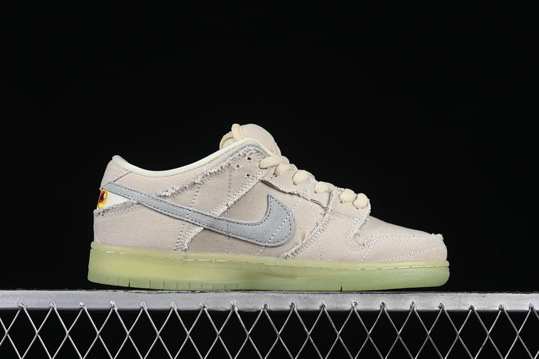 Side profile of the shoe showing the gray Swoosh and pale upper