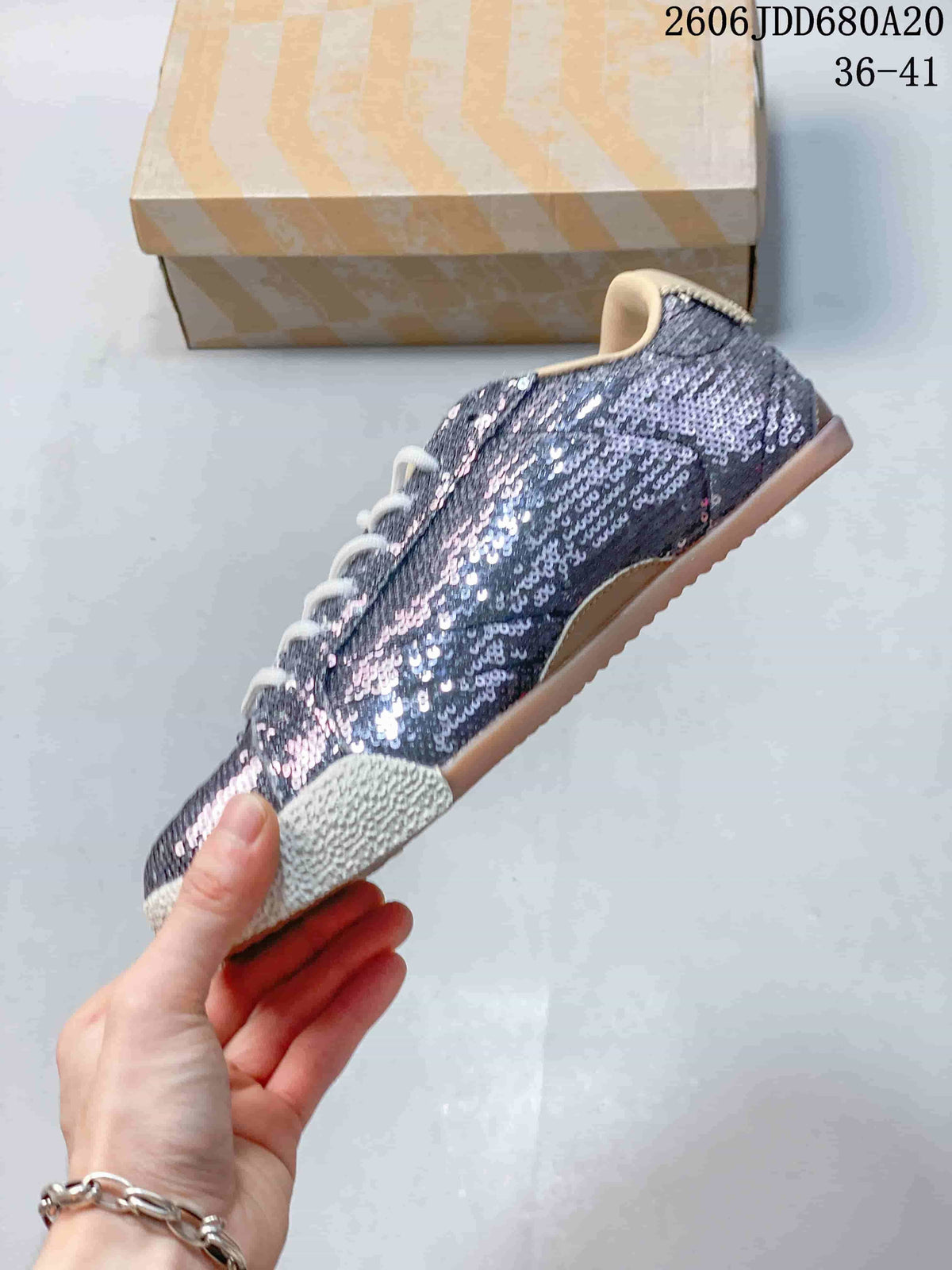 Side view showing the sequin upper, star detail, laces, and textured sole