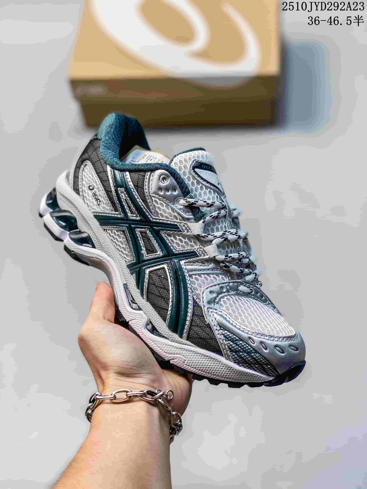Silver ASICS Gel-Nimbus sneaker with dark teal side stripes and mesh panels.