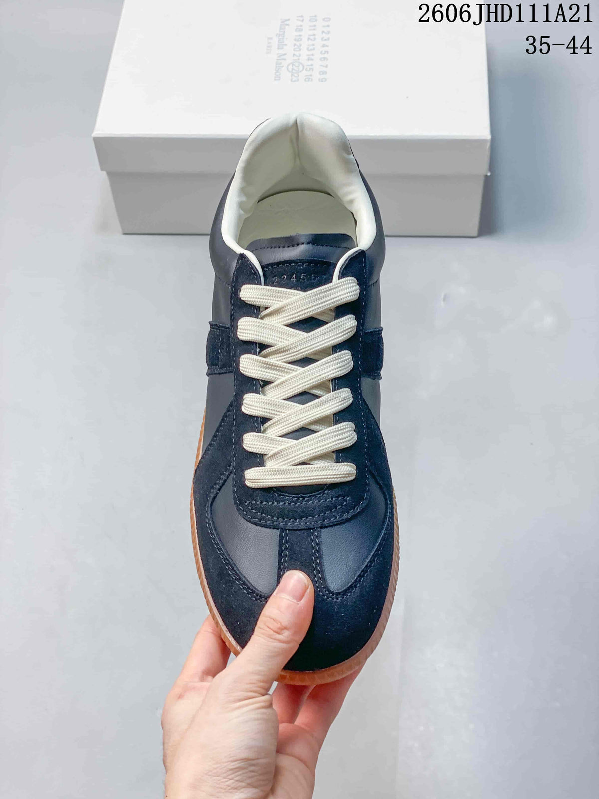 Top view of the sneaker showing cream laces and a panelled toe