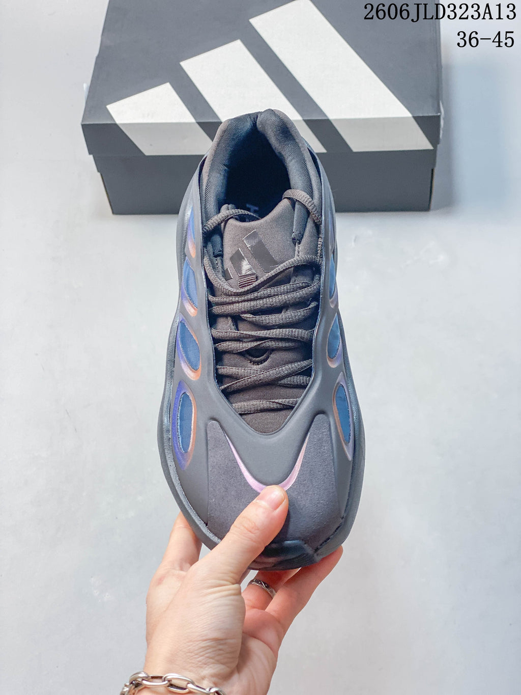 Top view of the gray sneaker showing its laces, tongue, and rounded toe.
