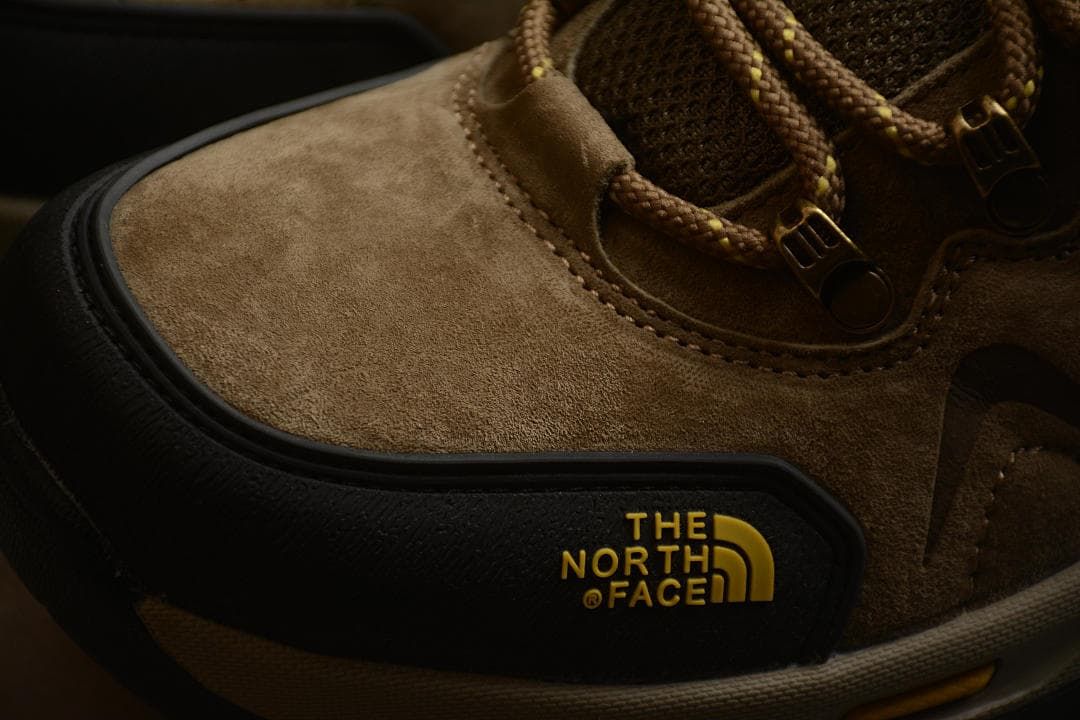 Close-up of the brown upper and black protective toe overlay