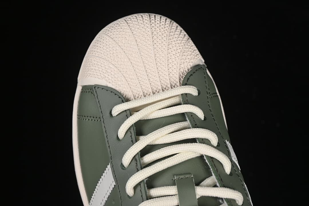 Top-down detail of the cream shell toe and white laces.