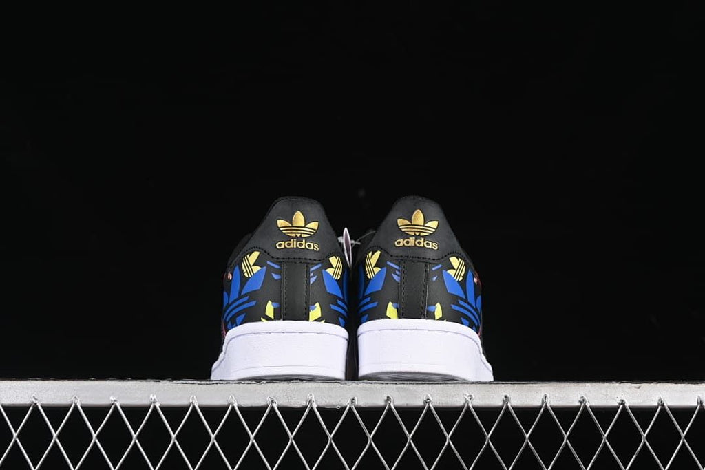 Rear view of both sneakers showing patterned heel panels
