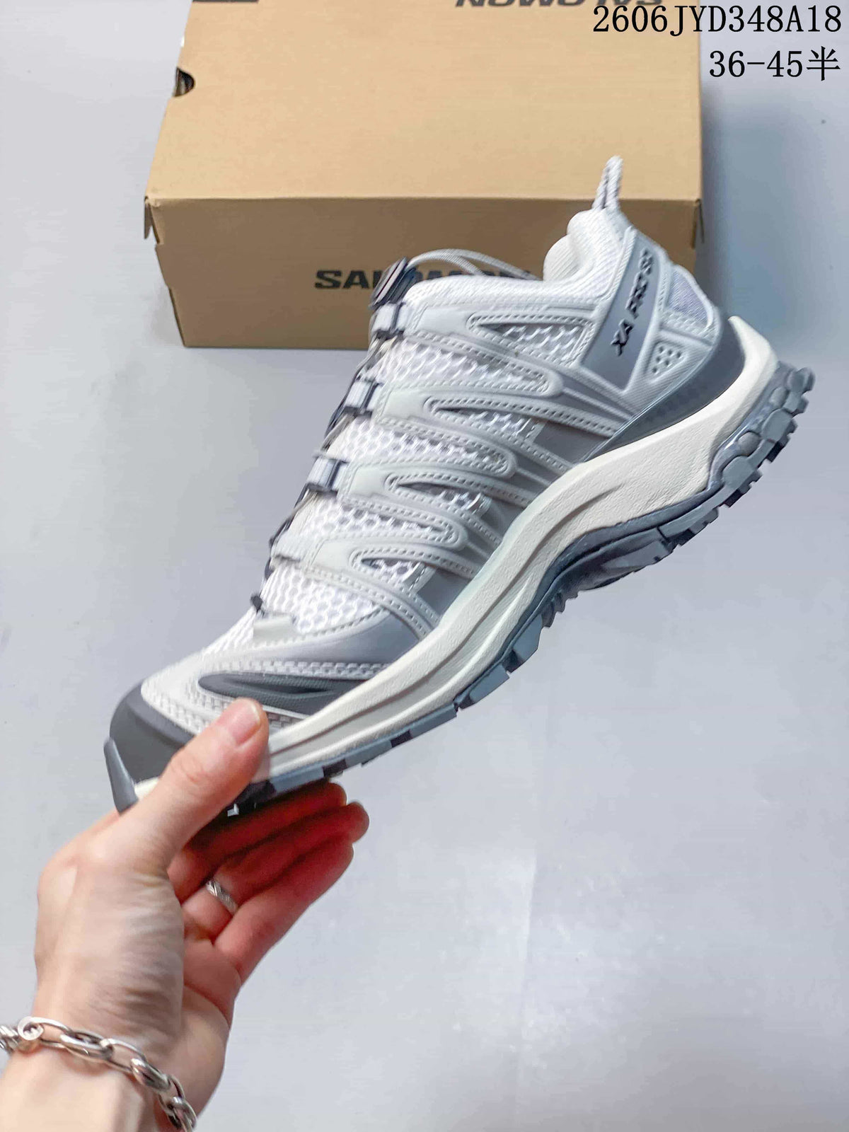 Side view showing the structured overlays and lugged outsole of the Salomon shoe.