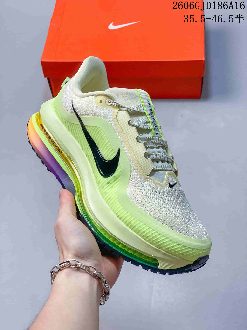Angled side view of the ivory and volt-green Nike Pegasus Premium sneaker