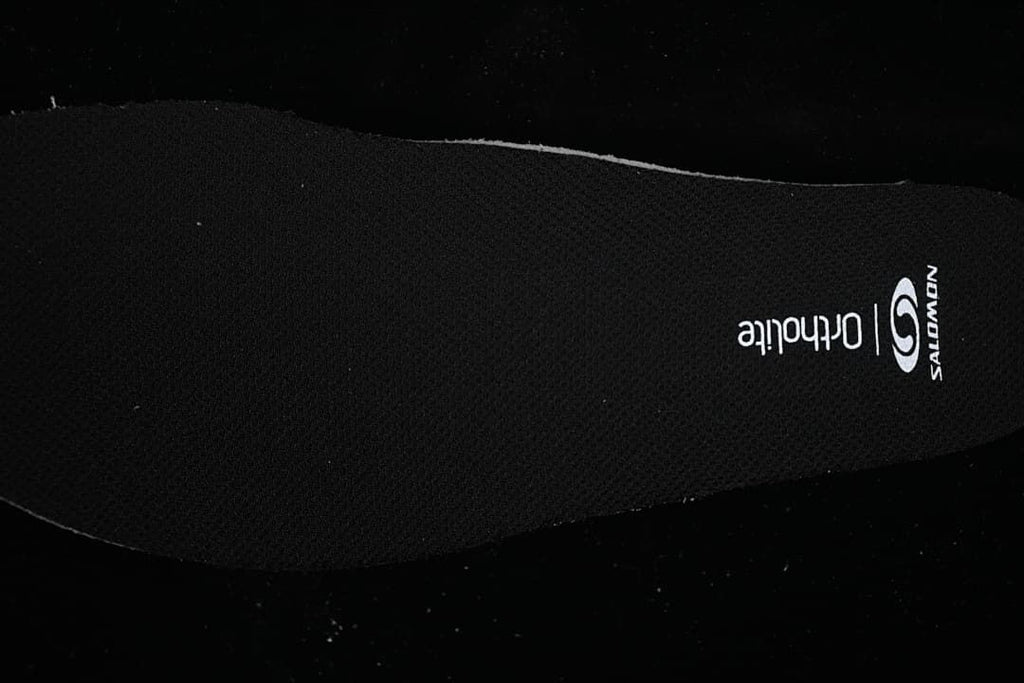 Close-up of the black insole with Salomon and Ortholite markings