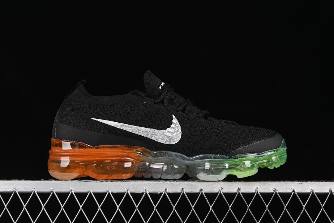 Side profile of a black VaporMax sneaker with white Swoosh and multicolor transparent sole.