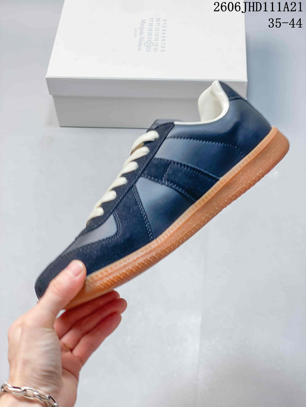 Side profile showing the navy panel design and gum-colored sole