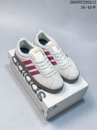 Pair of off-white Adidas sneakers with burgundy side stripes displayed on an Adidas shoebox.