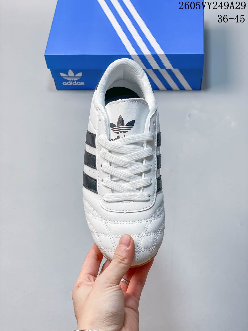 Top view of a white adidas Taekwondo sneaker with white laces and quilted toe stitching
