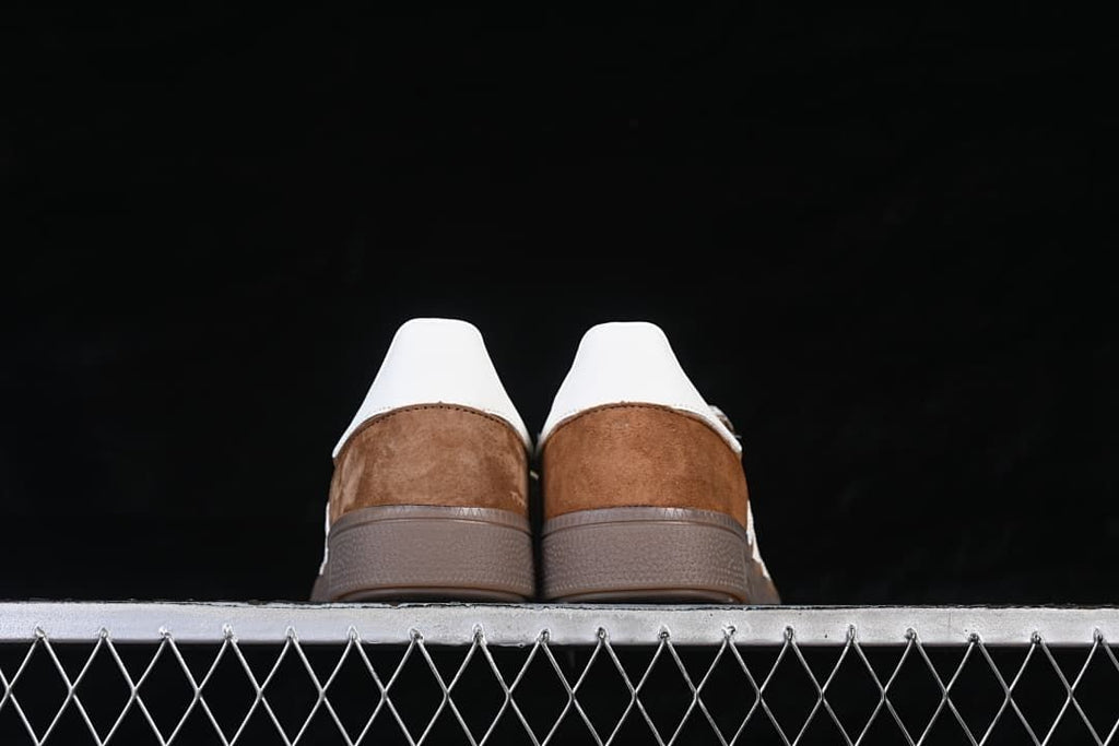 Rear view of both shoes showing heel tabs and gum-tone soles