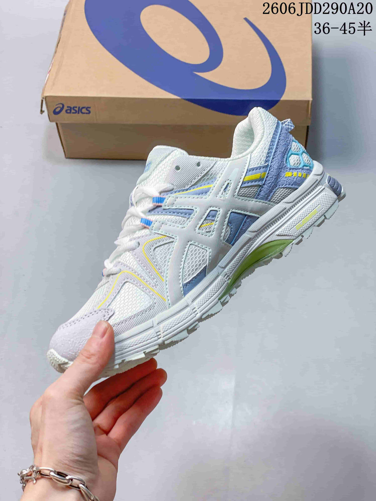 Side profile of a light-colored lace-up shoe with layered panels and colorful accents.