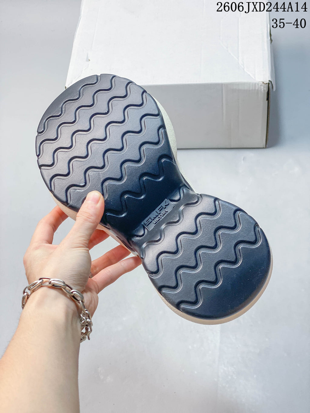 View of the navy outsole with wavy tread on an SMFK sneaker