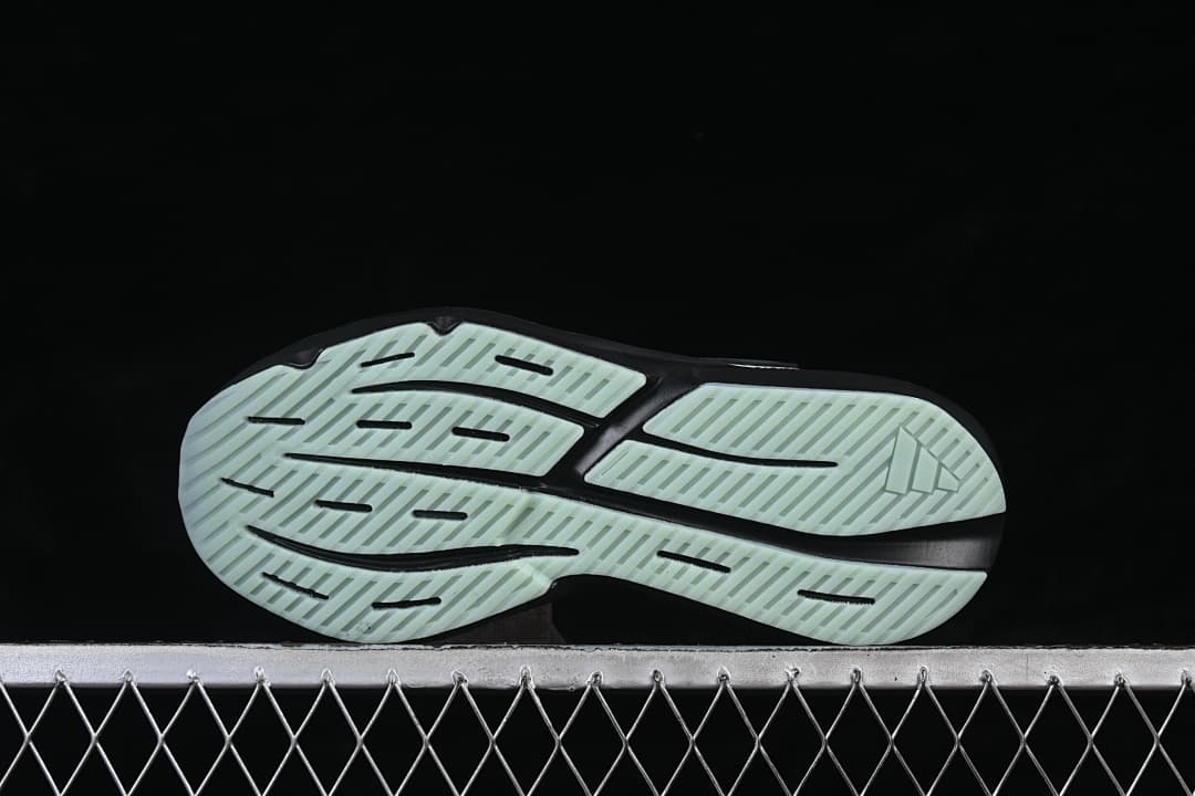 Outsole of the Adidas Lightblaze shoe with pale mint tread and black grooves