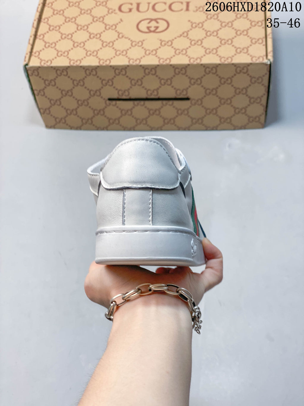Rear view of a white sneaker showing the heel panel and sole.