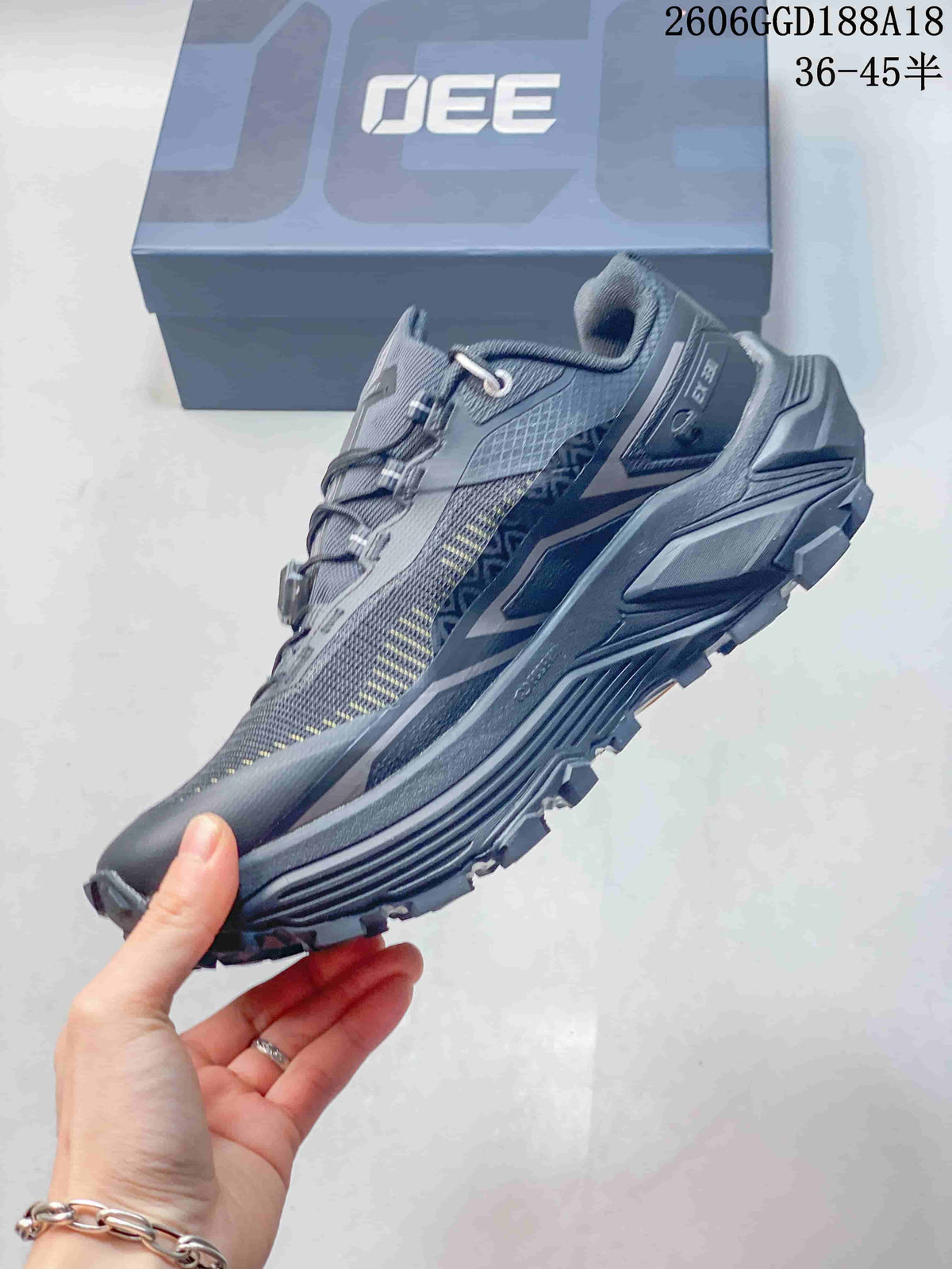 Side view of the gray trail running shoe with quick-lacing closure