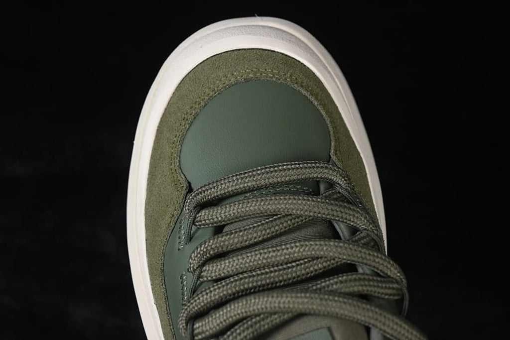 Top-down view of the green sneaker's toe and lacing