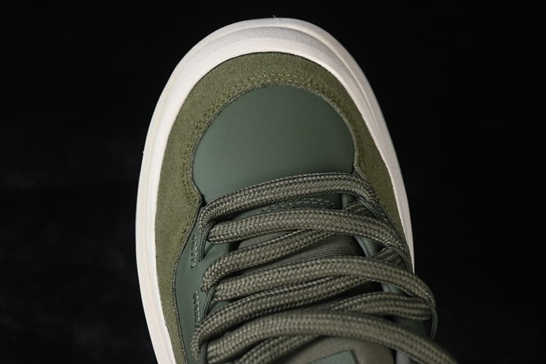 Top-down view of the green sneaker's toe and lacing