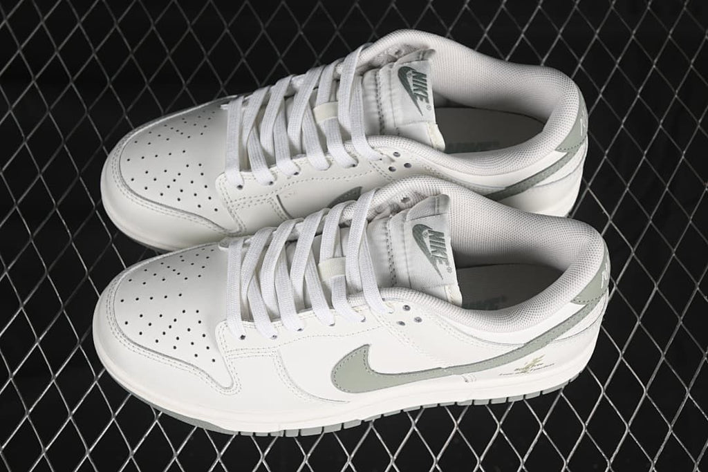 Pair of white and grey-green Nike SB Dunk Low sneakers