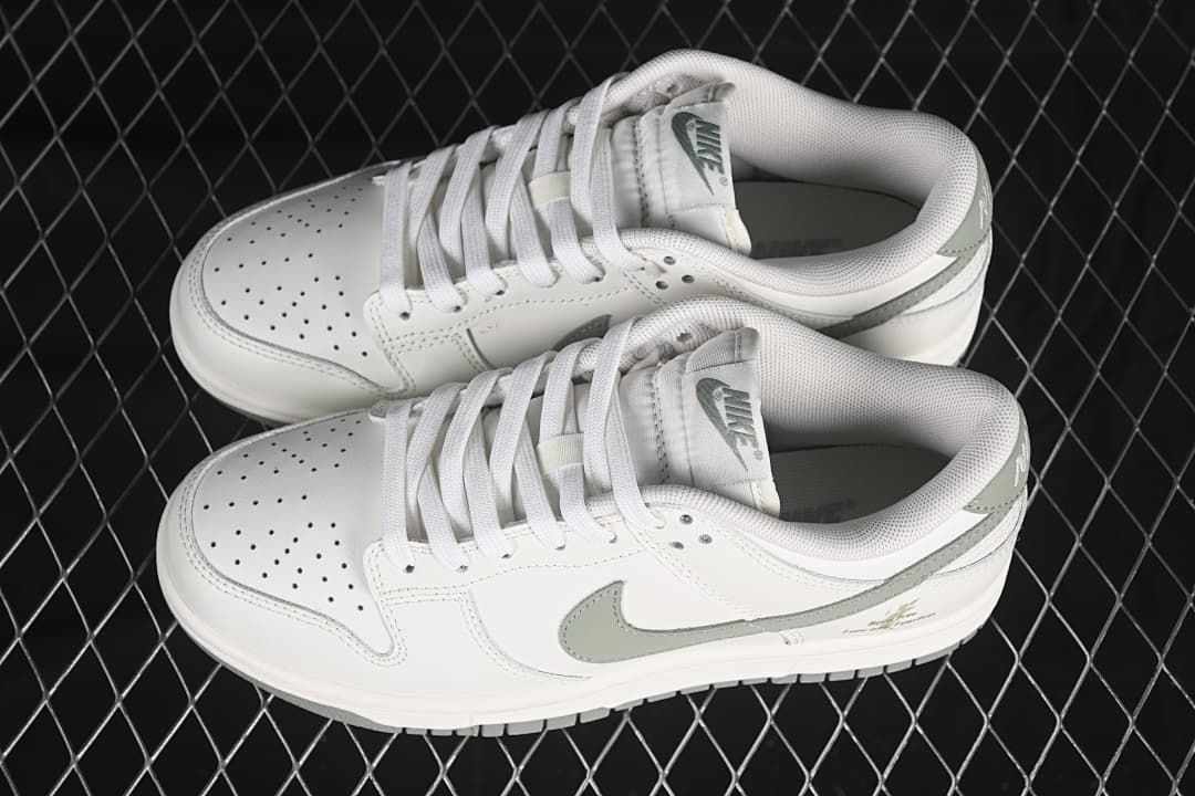 Pair of white and grey-green Nike SB Dunk Low sneakers