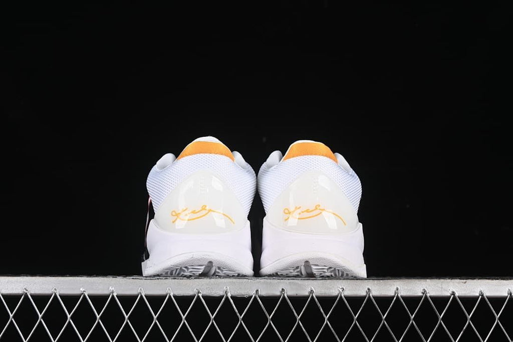 Rear view of the pair with yellow heel accents and signature details