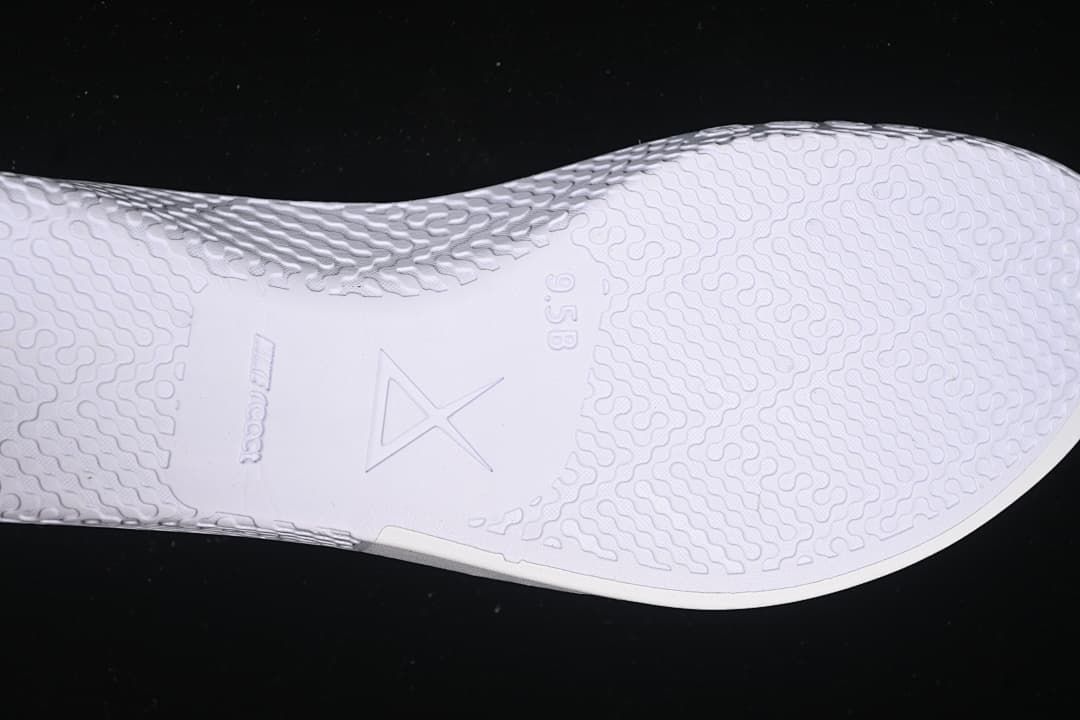 Close-up of white outsole texture and central Kobe logo