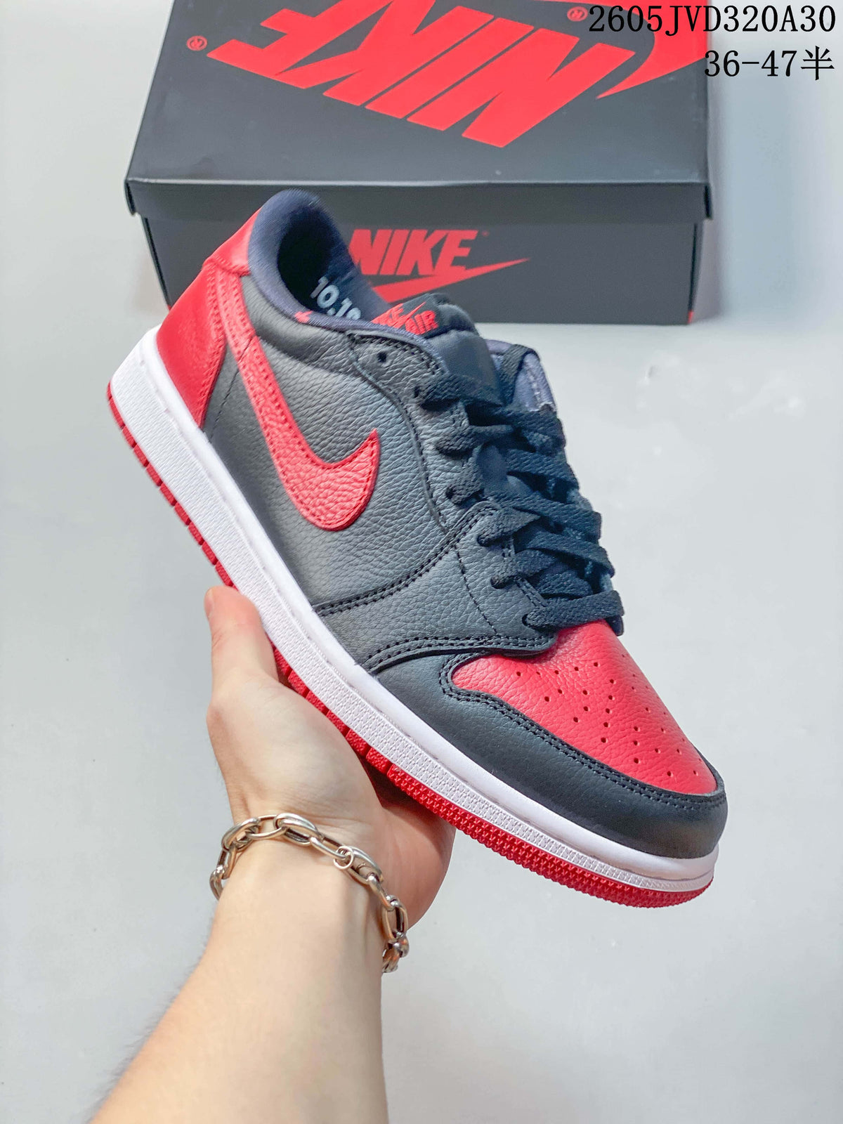 Angled side view of the red and dark grey low-top sneaker