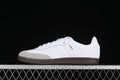 Side profile of a white adidas Samba OG sneaker with a light gray toe panel and dark gum sole